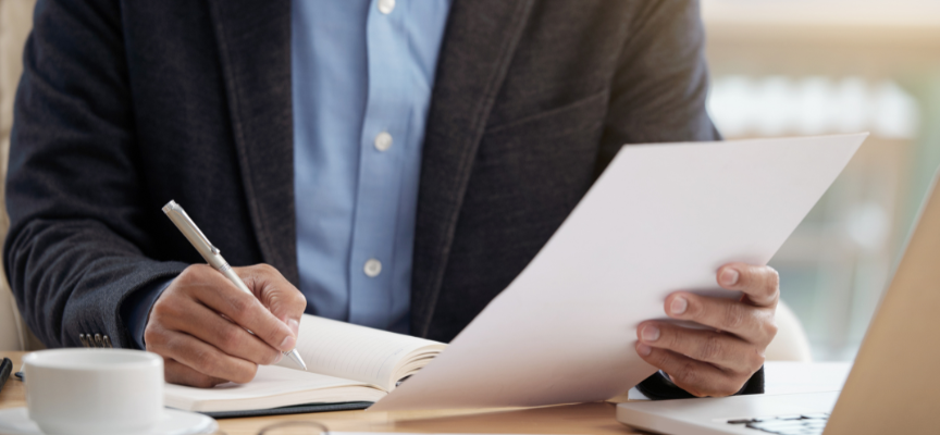 Lawyer reviewing witness statements and legal documents during the preparation of a criminal defence case in Alberta.
